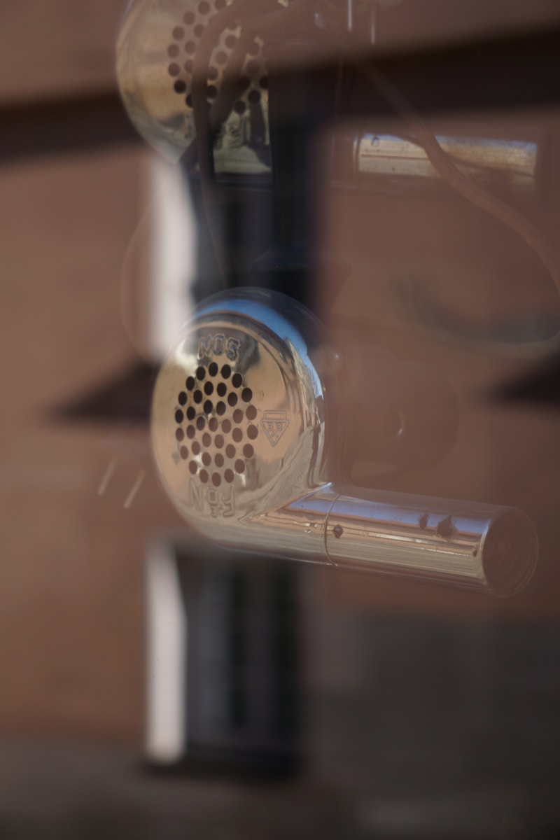 a close up of a traffic light with a building in the background